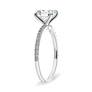 Diamond accented engagement ring with 1ct round cut lab grown diamond in 14k white gold band shown from side