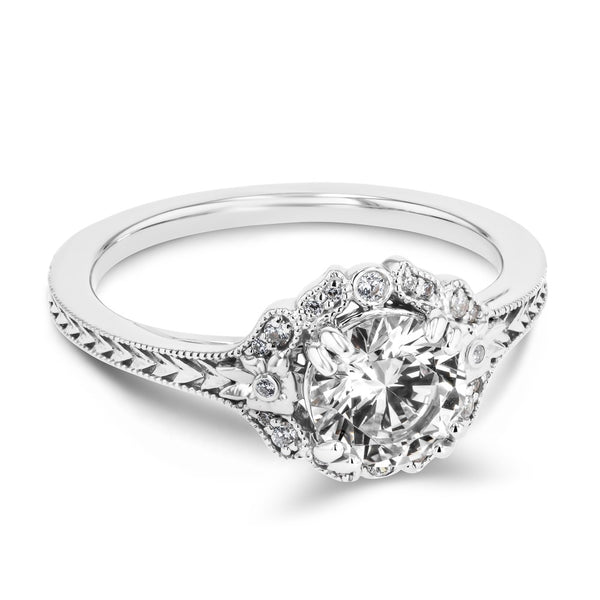 Shown here with a 1.0ct Round Cut Lab Grown Diamond center stone in 14K White Gold|diamond halo engagement ring with chevron detailed band set with a round cut lab grown diamond center stone in 14k white gold recycled metal