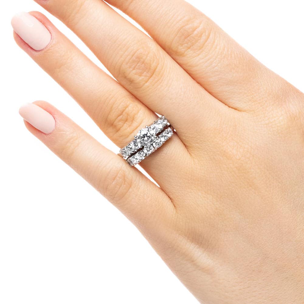 Shown with a 1.0ct Round cut Lab-Grown Diamond with six accenting stones on the band in recycled 14K white gold with matching wedding band, can be purchased together for a discounted price