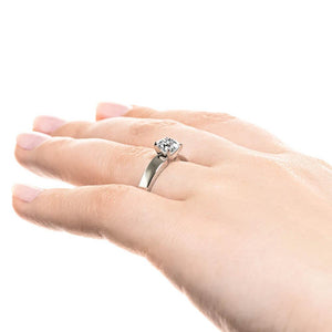 Modern solitaire engagement ring with 1ct round cut lab grown diamond in thick 14k white gold band worn on hand sideview