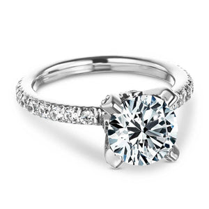 Beautiful vintage style diamond accented engagement ring with peek-a-boo diamonds under a 1.5ct round cut lab grown diamond in a 14k white gold setting