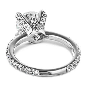 Vintage style diamond accented engagement ring with peek-a-boo diamonds under a 1.5ct round cut lab grown diamond in a 14k white gold band shown from behind