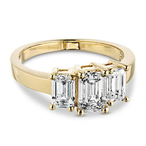 kim kardashian look-a-like engagement ring with three emerald cut lab grown diamonds in 14k yellow gold band