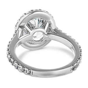 Diamond accented halo engagement ring with 2ct oval cut lab grown diamond in 14k white gold band shown from back