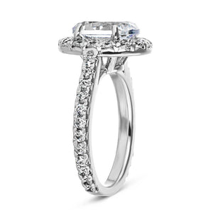 Diamond accented halo engagement ring with 2ct oval cut lab grown diamond in 14k white gold band shown from side