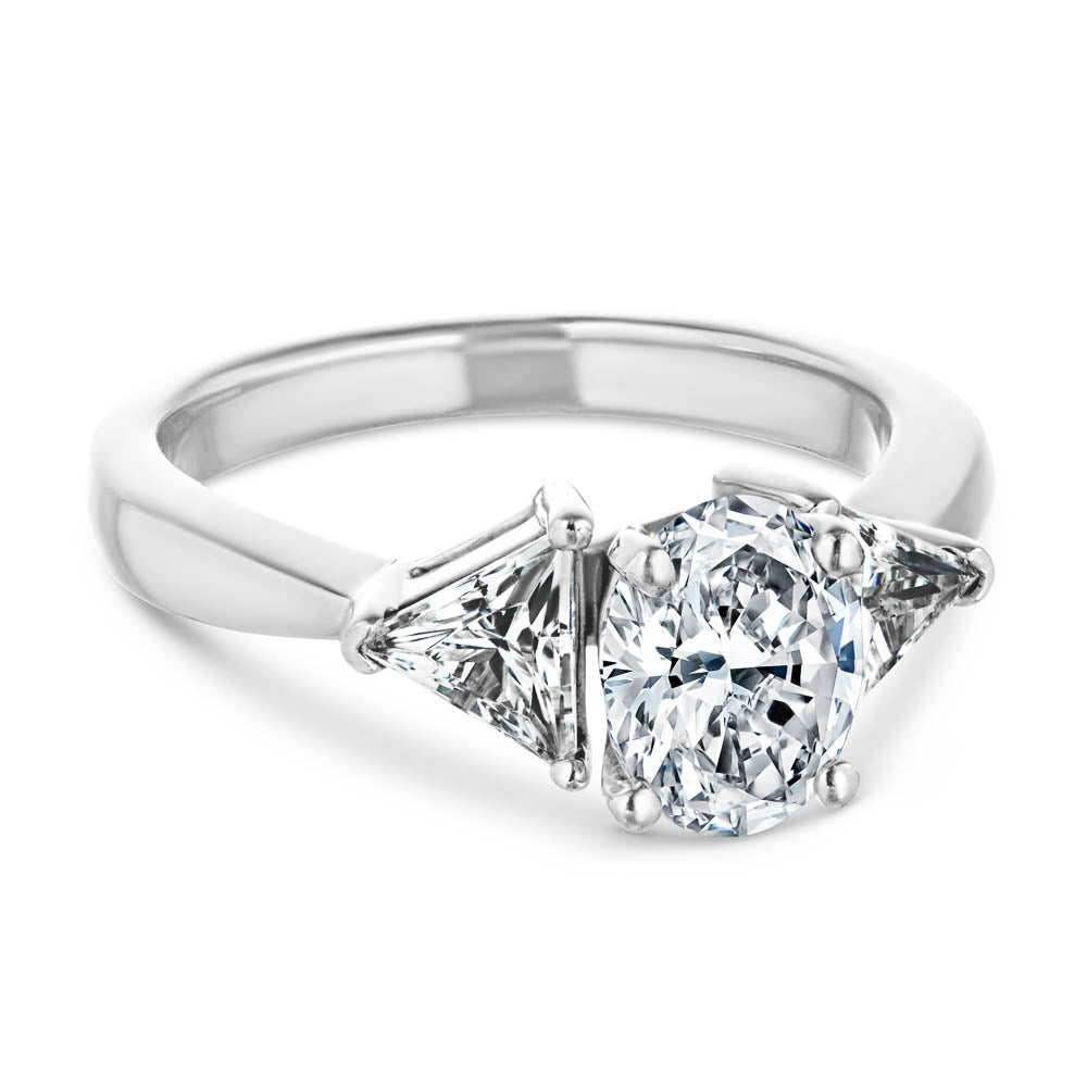 Shown with 1ct Oval Cut Lab Grown Diamond & 0.50ct Triangle Cut Side Stones in 14k White Gold|Unique three stone engagement ring with 1ct oval cut lab grown diamond and two 0.50 triangle cut diamond side stones in 14k white gold setting