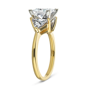 Three stone engagement ring with 1.5ct princess cut lab grown diamond and two 0.50 triangle cut diamond side stones in 14k yellow gold shown from side