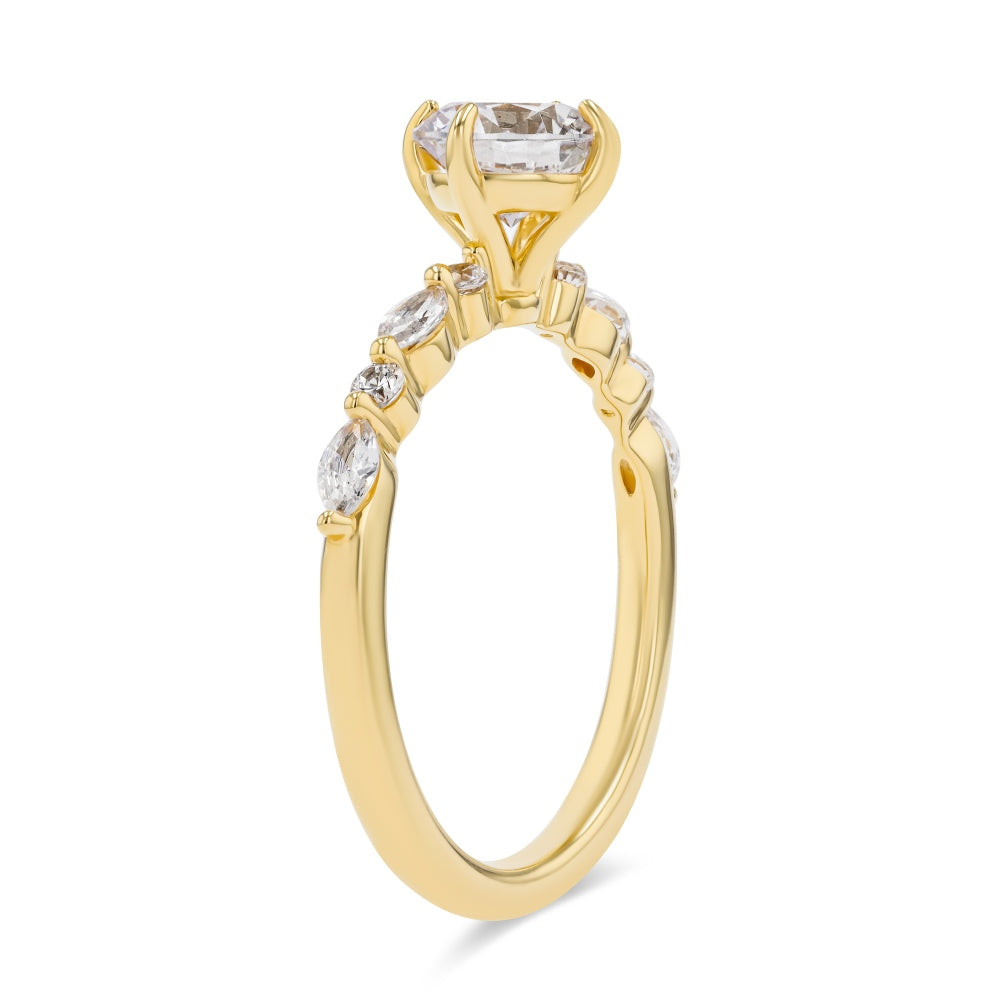 Shown here with a 1.0ct Round Cut center stone in 14K Yellow Gold|summer engagement ring with diamond accenting stones and a round cut center stone set in 14k yellow gold metal