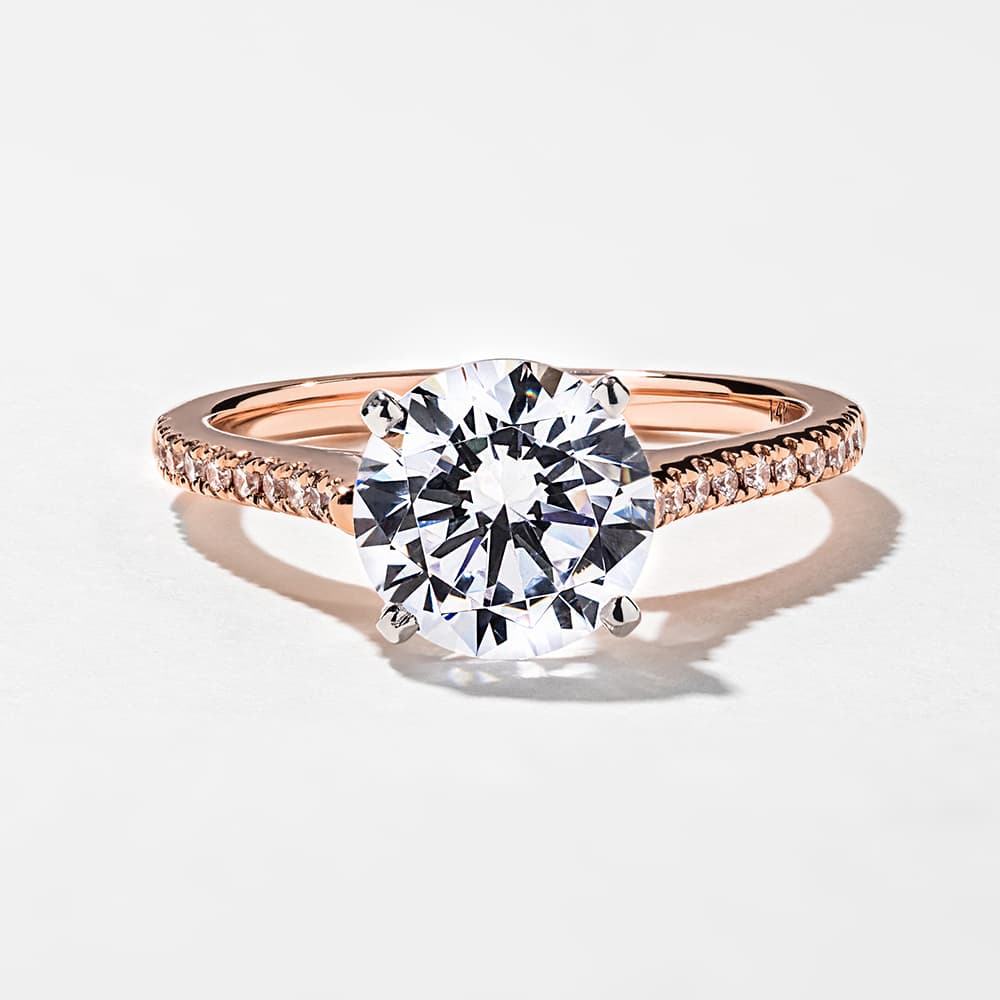 Shown with 1.5ct Round Cut Lab-Grown Diamond in 14k Rose Gold with a White Gold Prong Head