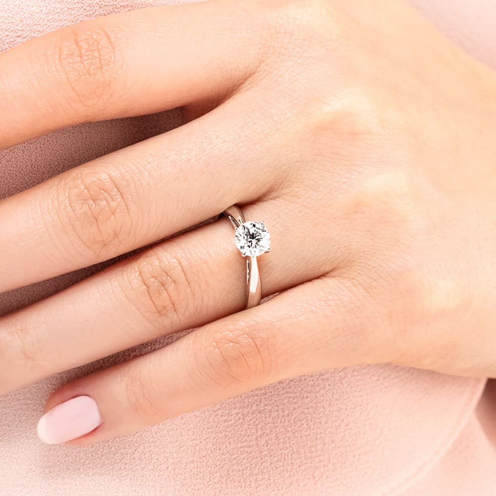 Shown with a 1ct Round Cut Lab Grown Diamond in 14k White Gold|Simple classic solitaire engagement ring with 1ct round cut lab grown diamond in cathedral style 14k white gold setting