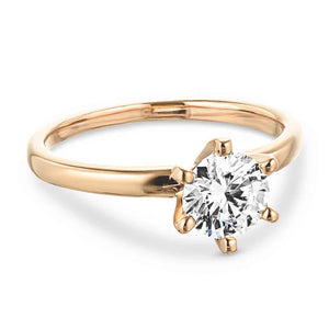  Lab-grown diamond rose gold four prong solitaire engagement ring.