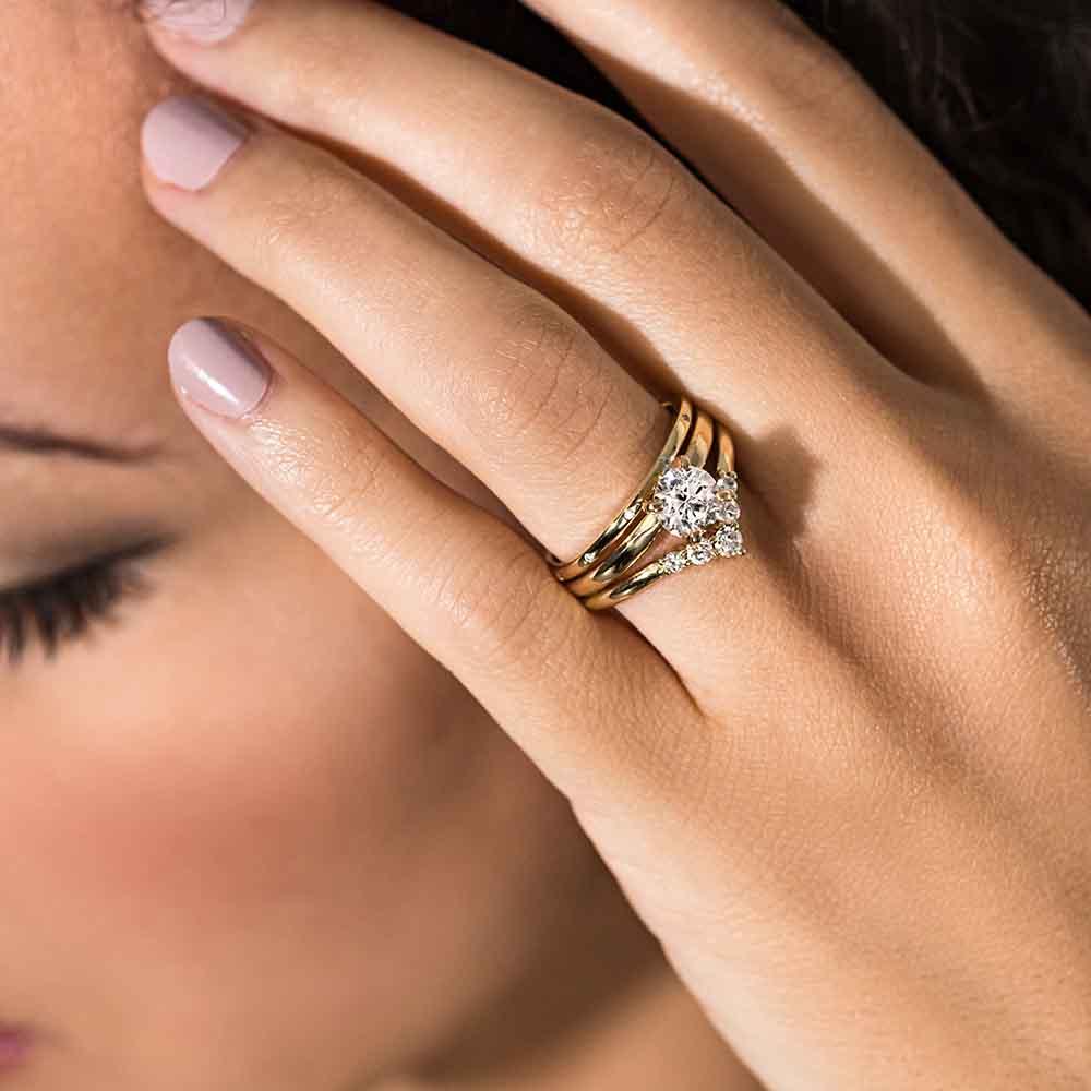 The traditional wedding set is shown here set with a  0.95ct lab-grown  diamond  in 14k yellow gold.  It is including an additional band. V Band sold separately. 