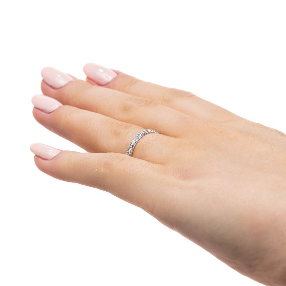 The Trinity Pavé Diamond Wedding band is accented with 0.20ctw recycled diamonds going halfway around the band, finished in recycled 14K white gold 