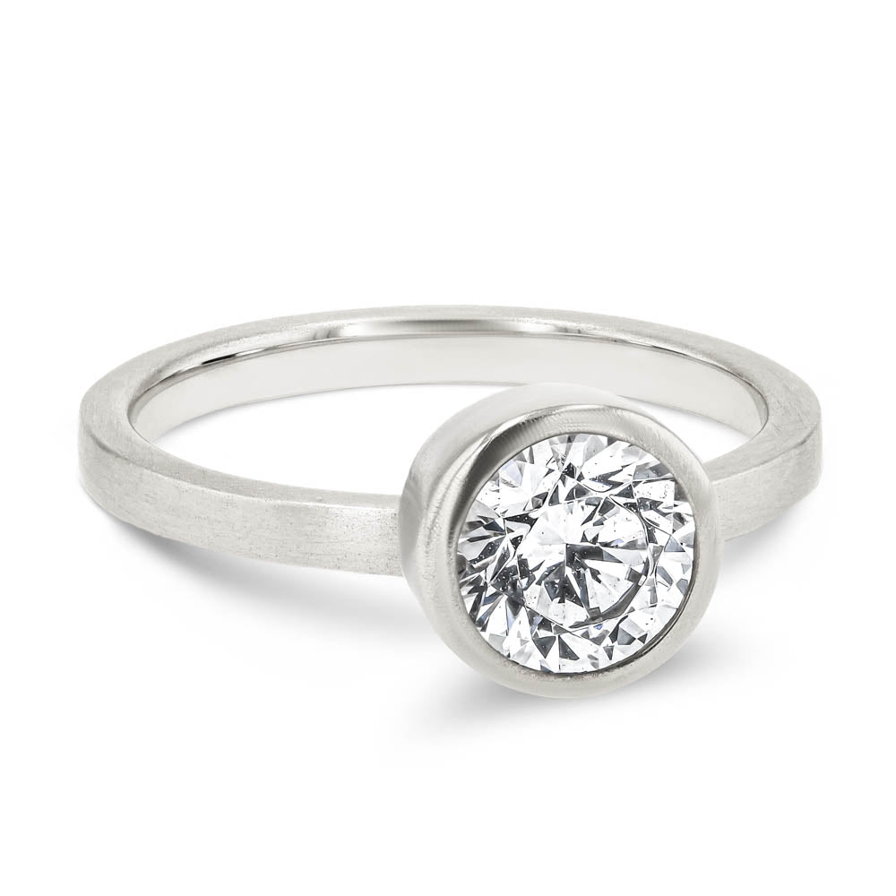 Shown in 14K White Gold with a Satin Finish|bezel set solitaire engagement ring with round cut lab grown diamond in satin finish 14k white gold metal