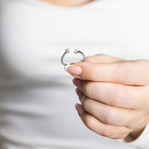 Woman Holding 14 Carat White Gold Open Center Band with Two Stone Pear Cut Lab Grown Diamonds from MiaDonna