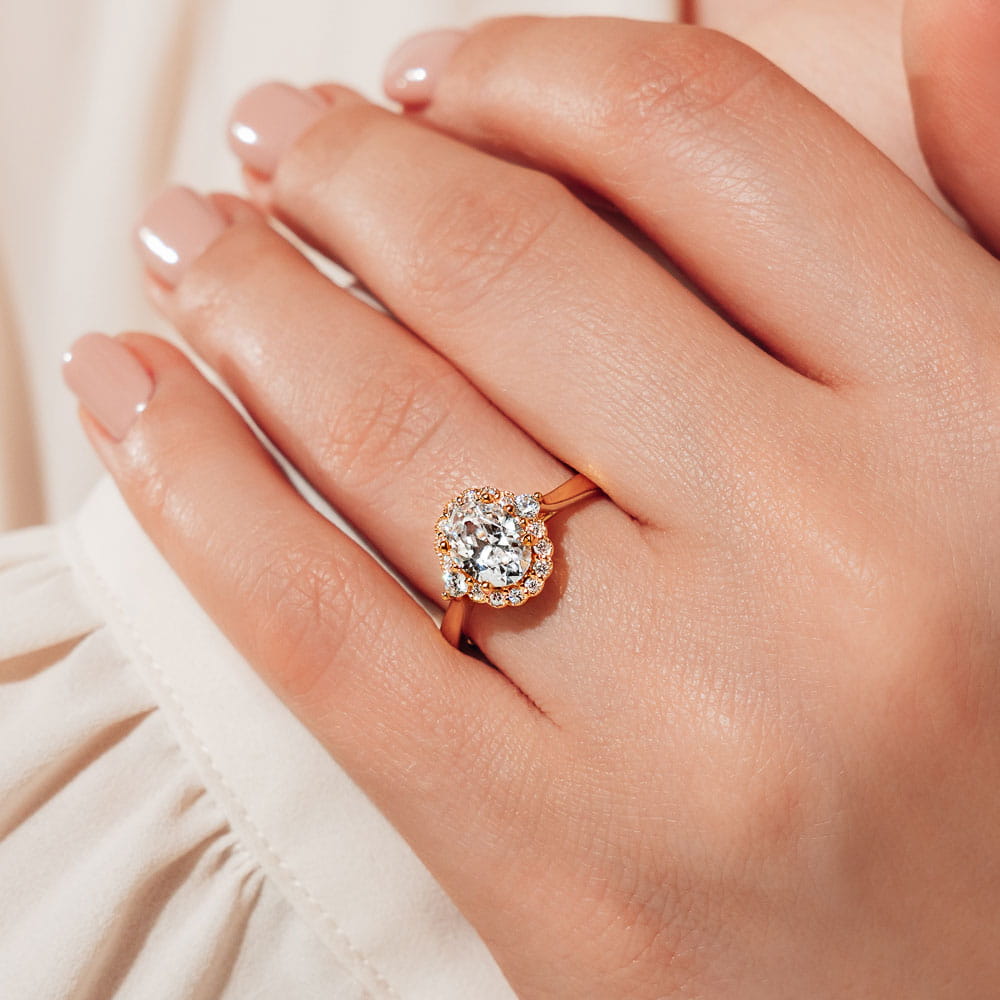 Shown with 1ct Round cut Lab Grown Diamond in 14k Yellow Gold|Vintage and antique style engagement ring with floral style diamond halo and a 1ct oval cut lab grown diamond in 14k yellow gold