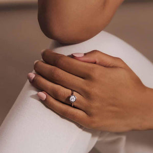 Elegant modern engagement ring with 1ct round cut bezel set lab grown diamond in 14k rose gold worn on hand