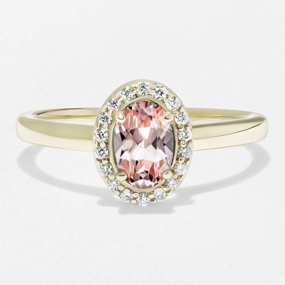 Shown with a Pink Champagne Sapphire Oval Cut center stone|halo engagement ring featuring a lab grown gemstone pink champagne sapphire center stone in yellow gold