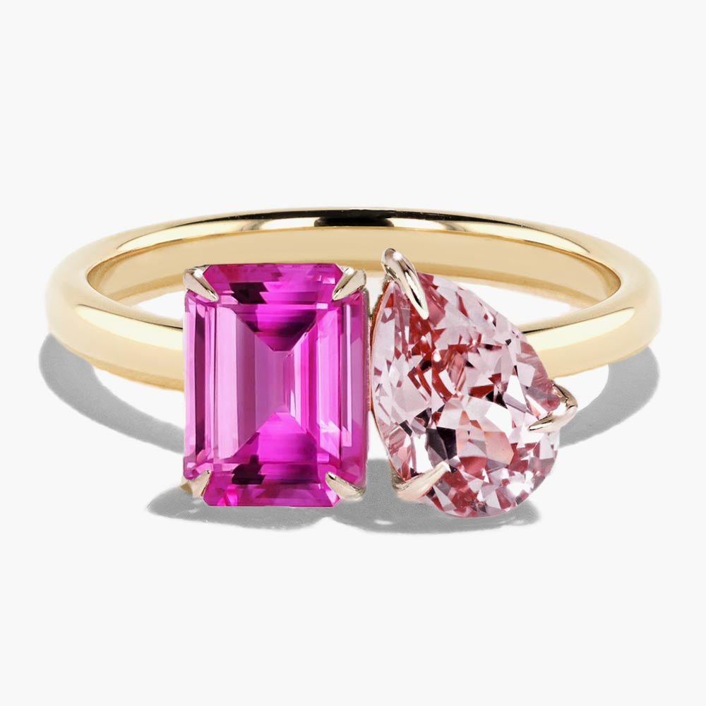 Shown in 14K Yellow Gold with an Emerald Cut Lab Created Pink Sapphire and a Pear Cut Lab Created Pink Champagne Sapphire|toi et moi two stone engagement ring with lab created pink sapphire and pink champagne sapphire emerald cut and pear cut set in 14k yellow gold recycled metal by MiaDonna