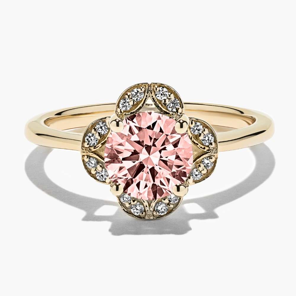 Shown here in 14K Yellow Gold with a Round Cut Pink Champagne Sapphire|vintage halo engagement ring with lab grown diamond accents and a round cut lab grown pink champagne sapphire gemstone set in recycled yellow gold by MiaDonna
