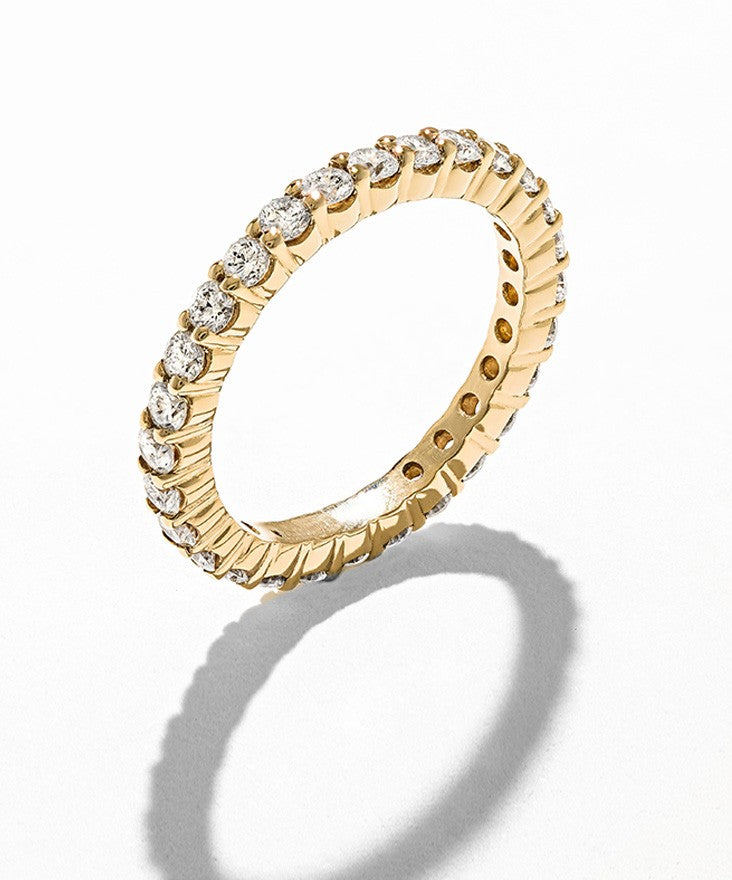 Sustainable diamond eternity band set with ethically sourced lab-grown diamonds and recycled metals .