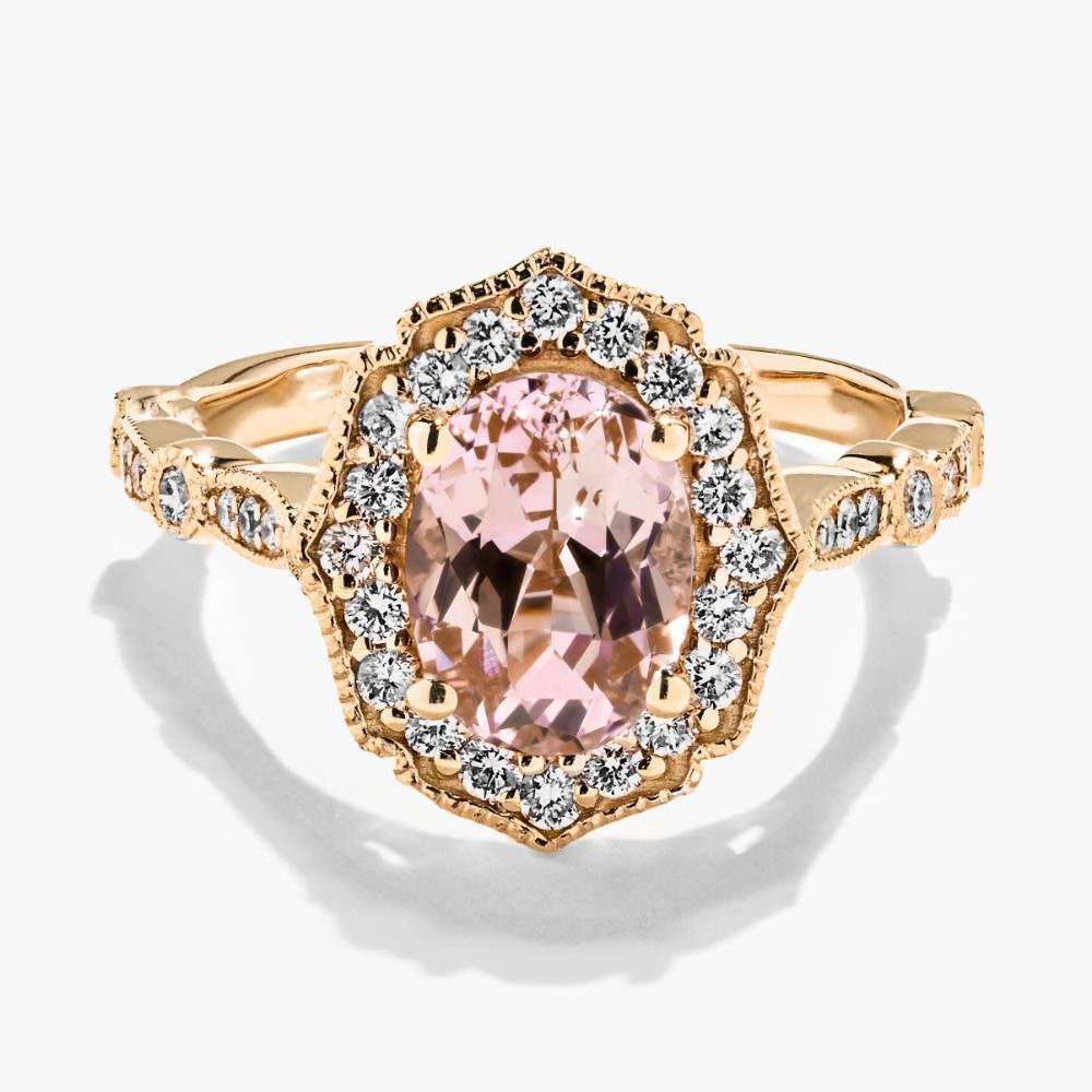 Shown here in 14K Yellow Gold with an Oval Cut Pink Champagne Sapphire|vintage diamond halo engagement ring featuring lab grown diamond accents and a pink champagne sapphire center stone