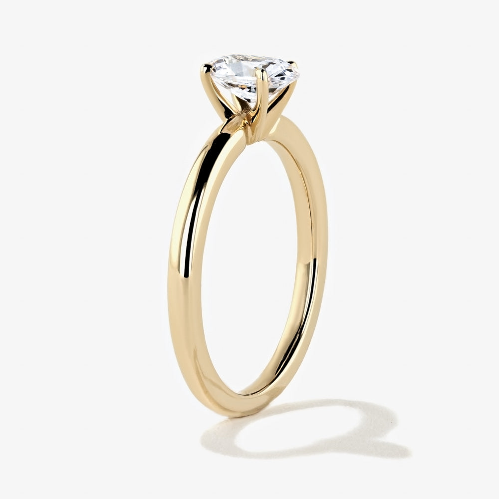 Shown in 14K Yellow Gold with an Oval Cut Center Stone