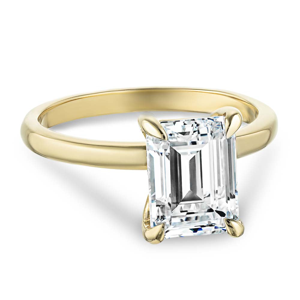 Shown in 14K Yellow Gold with a 2ct Emerald Cut Lab Grown Diamond center stone|traditional solitaire claw prong engagement ring in 14k recycled yellow gold metal with emerald cut lab grown diamond by MiaDonna