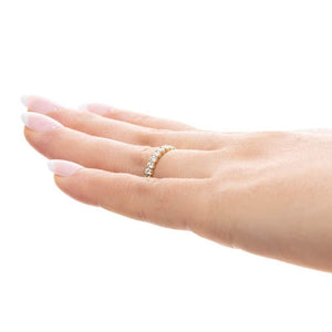 Diamond accented wedding band with 11 round cut lab grown diamonds set in 14k yellow gold shown worn on hand sideview