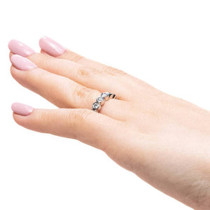 Bezel set lab grown diamond wedding band in recycled 14k white gold worn on hand sideview