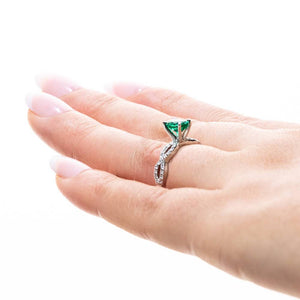 Antique style diamond accented engagement ring with 1ct oval cut lab created emerald in 14k white gold worn on hand