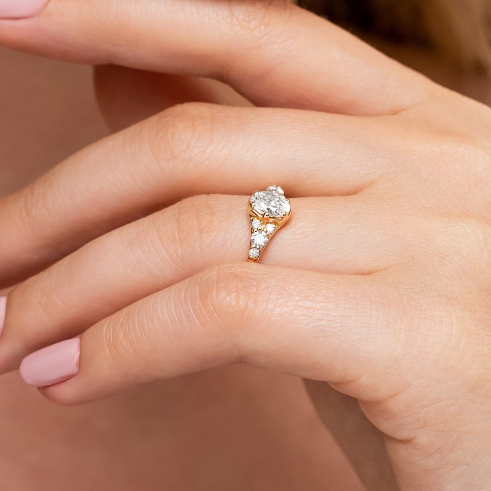 Shown with a 1.0ct Oval cut Lab-Grown Diamond in recycled 14K yellow gold with accenting stones