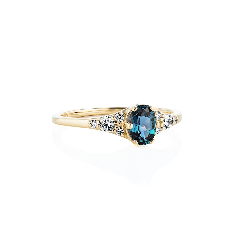 Shown with a 1.0ct Oval cut Lab-created Blue Sapphire Gemstone in recycled 14K yellow gold with accenting stones