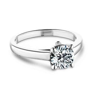 Simple traditional solitaire engagement ring with peek-a-boo diamond and 1ct round cut lab created diamond set in 14k recycled white gold