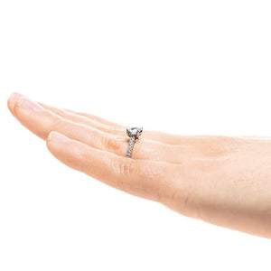 Hidden halo diamond accented engagement ring with 1ct round cut lab grown diamond in 14k white gold worn on hand worn on hand shown from side