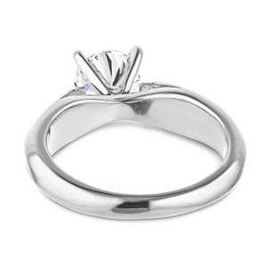 Modern solitaire engagement ring with wide band and cathedral style design featuring 1ct round cut lab grown diamond in platinum shown from back