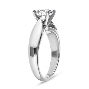 Modern solitaire engagement ring with wide band and cathedral style design featuring 1ct round cut lab grown diamond in platinum shown from side