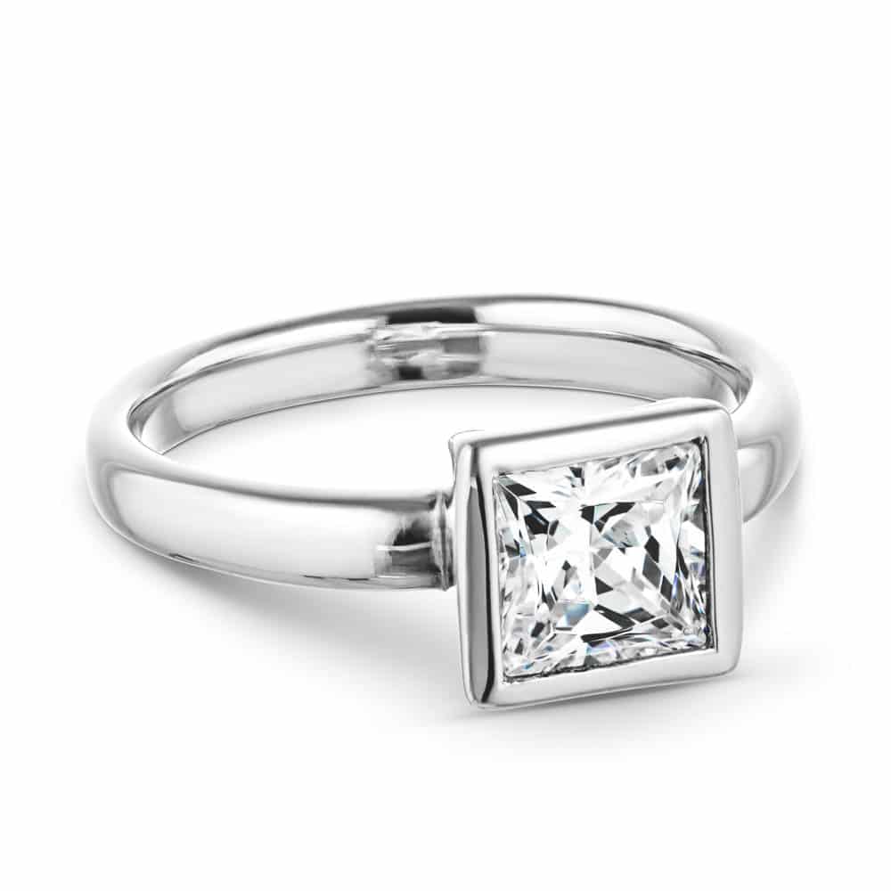 Shown with 1.5ct Princess Cut Lab Grown Diamond in 14k White Gold|Modern sleek minimalistic solitaire engagement ring with 1.5ct princess cut bezel set lab grown diamond in 14k white gold