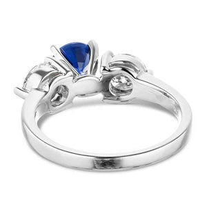 Three stone engagement with round cut lab grown diamonds and lab created blue sapphire center stone in 14k white gold back view