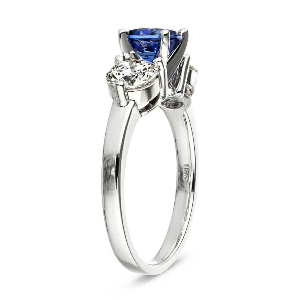 Shown with Round Cut Lab Grown Diamonds on either side of a Lab Created Blue Sapphire in 14k White Gold