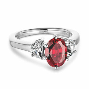Beautiful three stone engagement ring with 1ct oval cut lab grown ruby and half moon cut diamond simulant side stones in 14k white gold