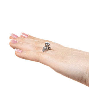Vintage style butterfly engagement ring with diamond accented milgrain detail band holding 1ct round cut lab grown diamond in 14k white gold worn on hand sideview