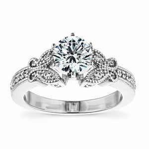 Beautiful vintage style butterfly engagement ring with diamond accented milgrain detail band holding 1ct round cut lab grown diamond in 14k white gold