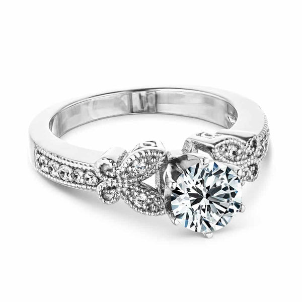 Shown with 1ct Round Cut Lab Grown Diamond in 14k White Gold|Vintage style butterfly engagement ring with diamond accented milgrain detail band holding 1ct round cut lab grown diamond in 14k white gold