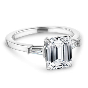 Baguette side stone engagement ring with 1ct emerald cut lab grown diamond in 14k white gold with peek-a-boo diamonds