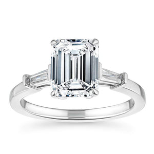 Beautiful baguette side stone engagement ring with 1ct emerald cut lab grown diamond in 14k white gold with peek-a-boo diamonds
