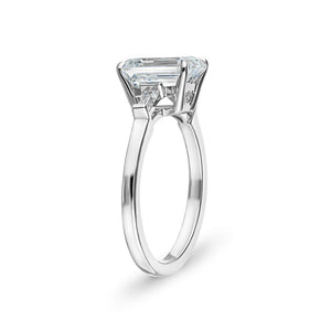 Baguette side stone engagement ring with 1ct emerald cut lab grown diamond in 14k white gold with peek-a-boo diamonds shown from side