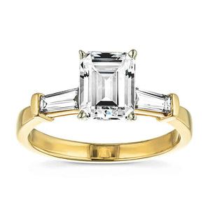 Modern three stone engagement ring with two baguette cut recycled diamond side stones and a 1.5ct emerald cut lab grown diamond center in 14k yellow gold