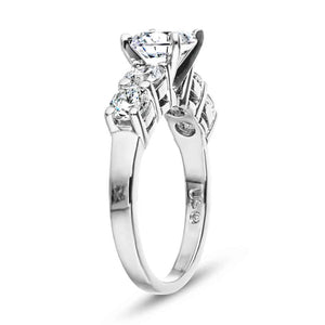 Accented engagement ring with a 1ct round cut lab grown diamond amid diamond hybrid simulants totaling 1ctw in 14k white gold shown from side