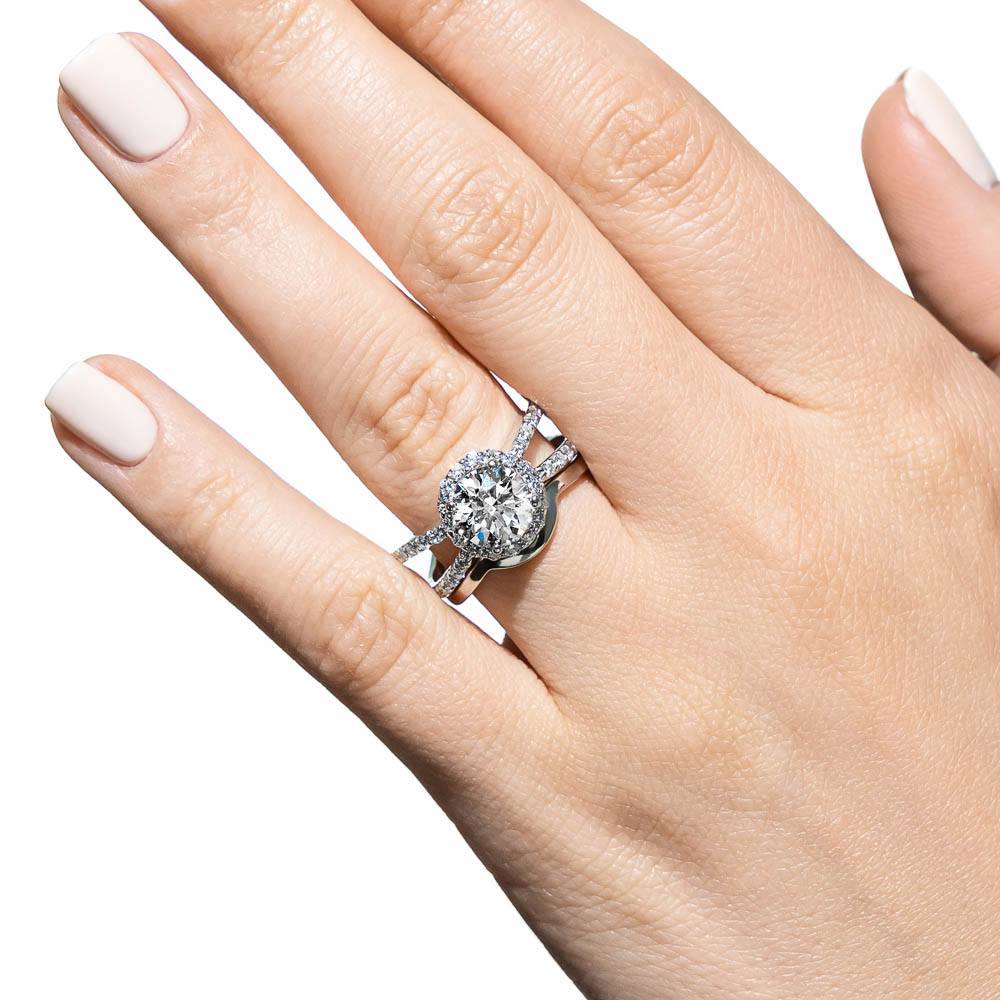 Shown with a 1.0ct Round cut Lab-Grown Diamond with diamond accented halo and split shank in recycled 14K white gold with matching wedding band